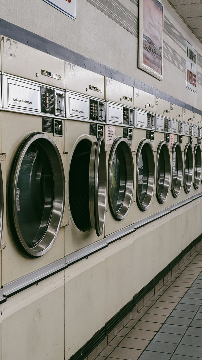 A classic laundromat in Chicago featuring a row of vintage washing machines.